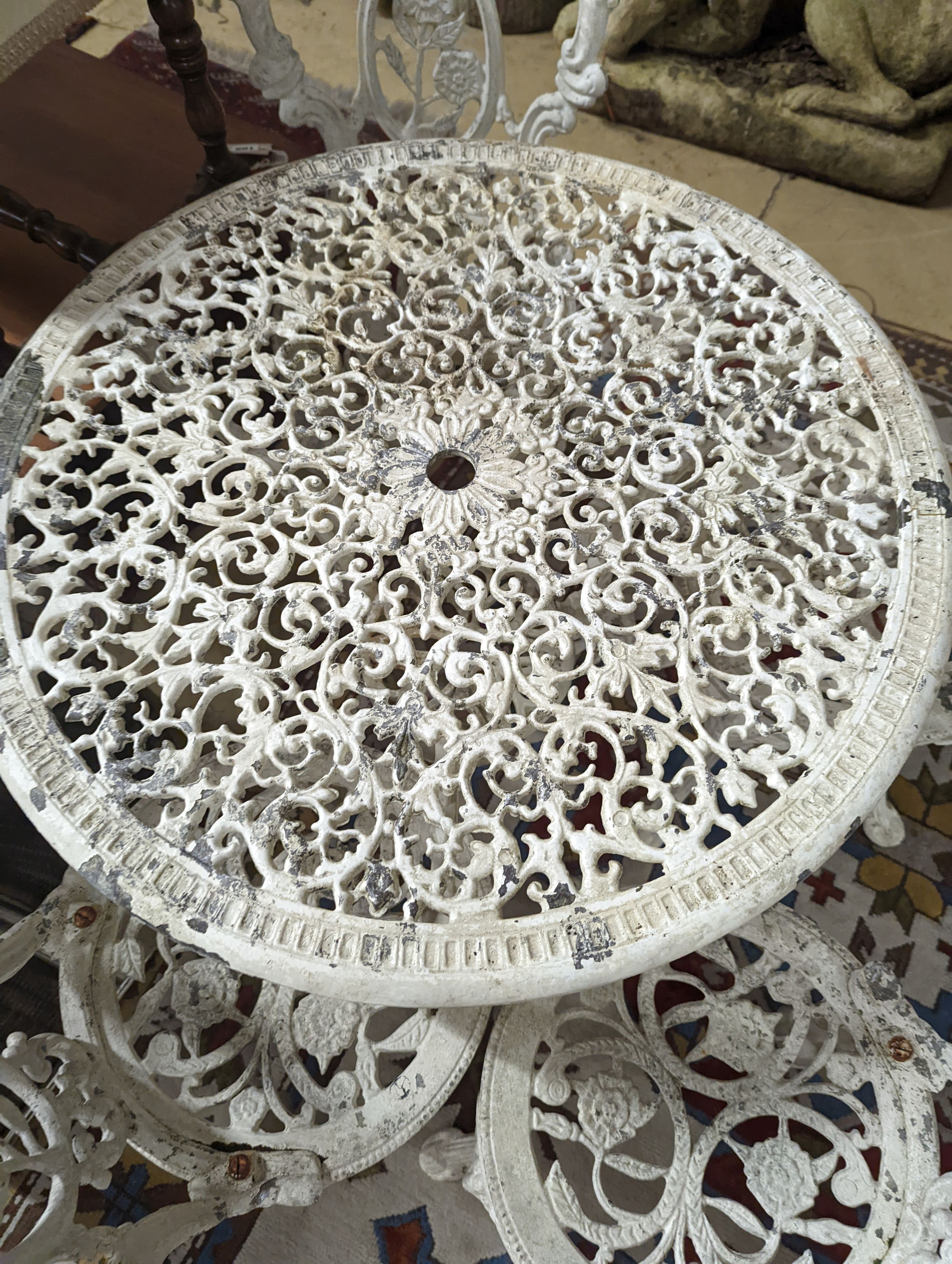 A Victorian style painted aluminium circular garden table, diameter 72cm, together with four chairs